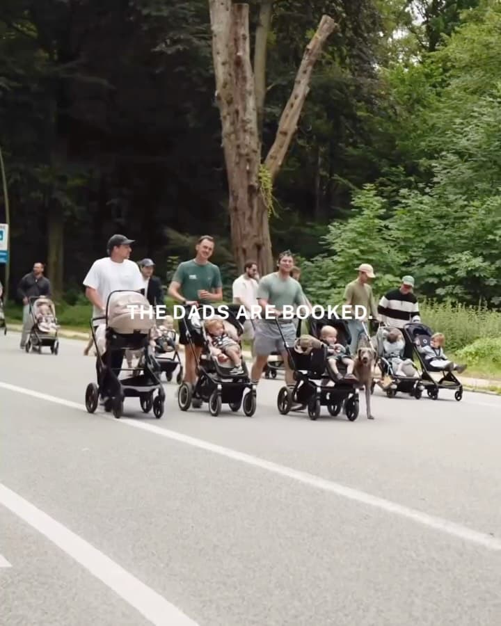 Fathers and children gathered at an outdoor community meetup event organized by Daddy Cours