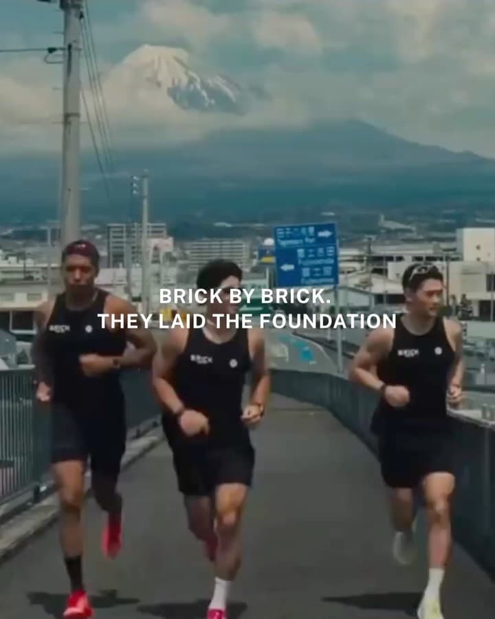 Runners from Brick by Tokyo run club gathering together on a Tokyo street at dusk, embodying their build daily be bold philosophy
