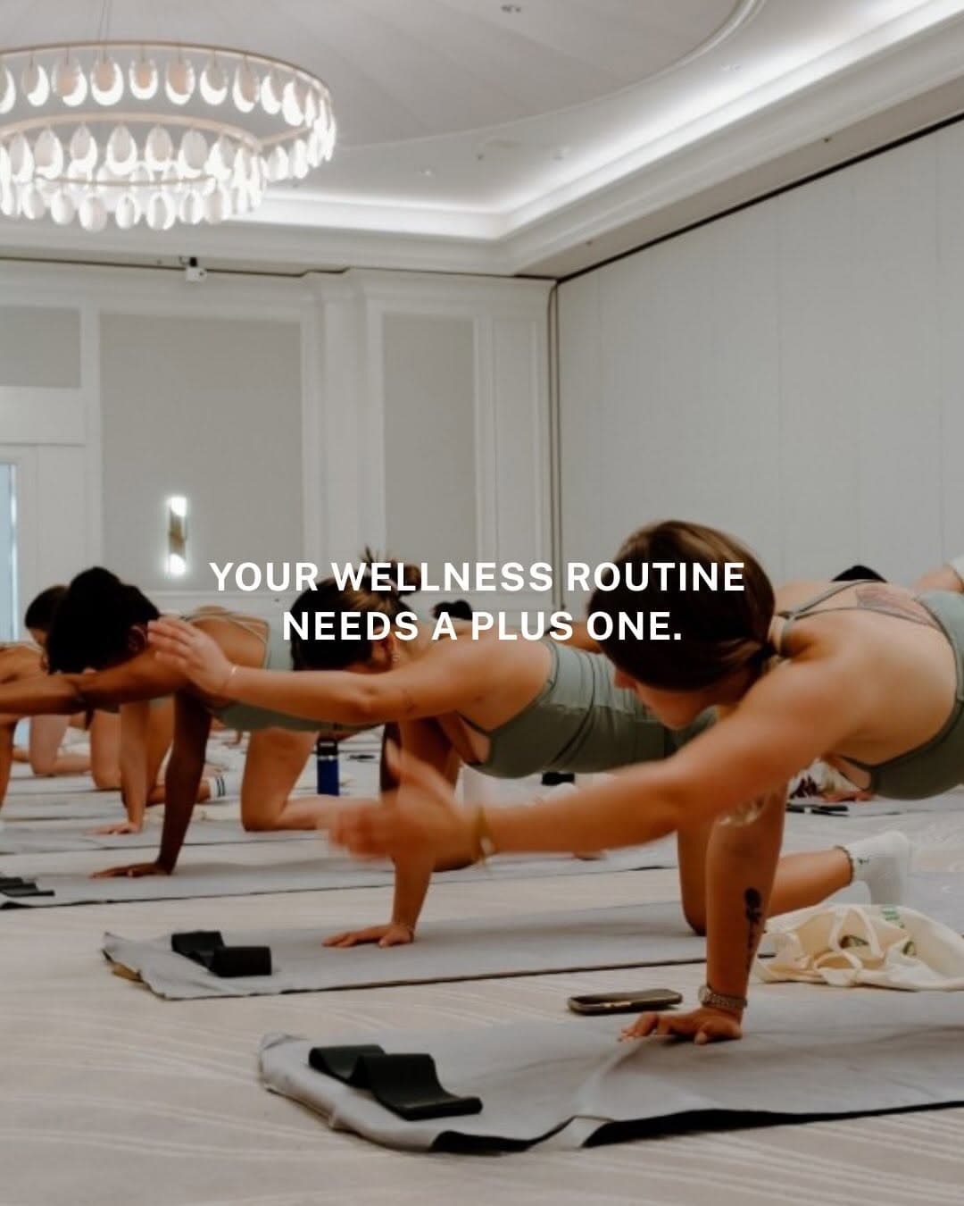 People on yoga mats in an elegant venue with natural light, gathering for a wellness event combining movement and socializing