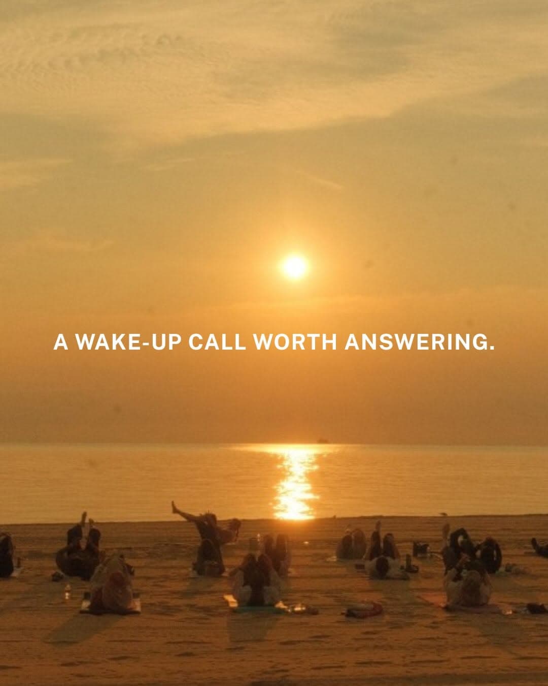 Women doing an outdoor Pilates session on the beach at sunrise with the ocean in the background