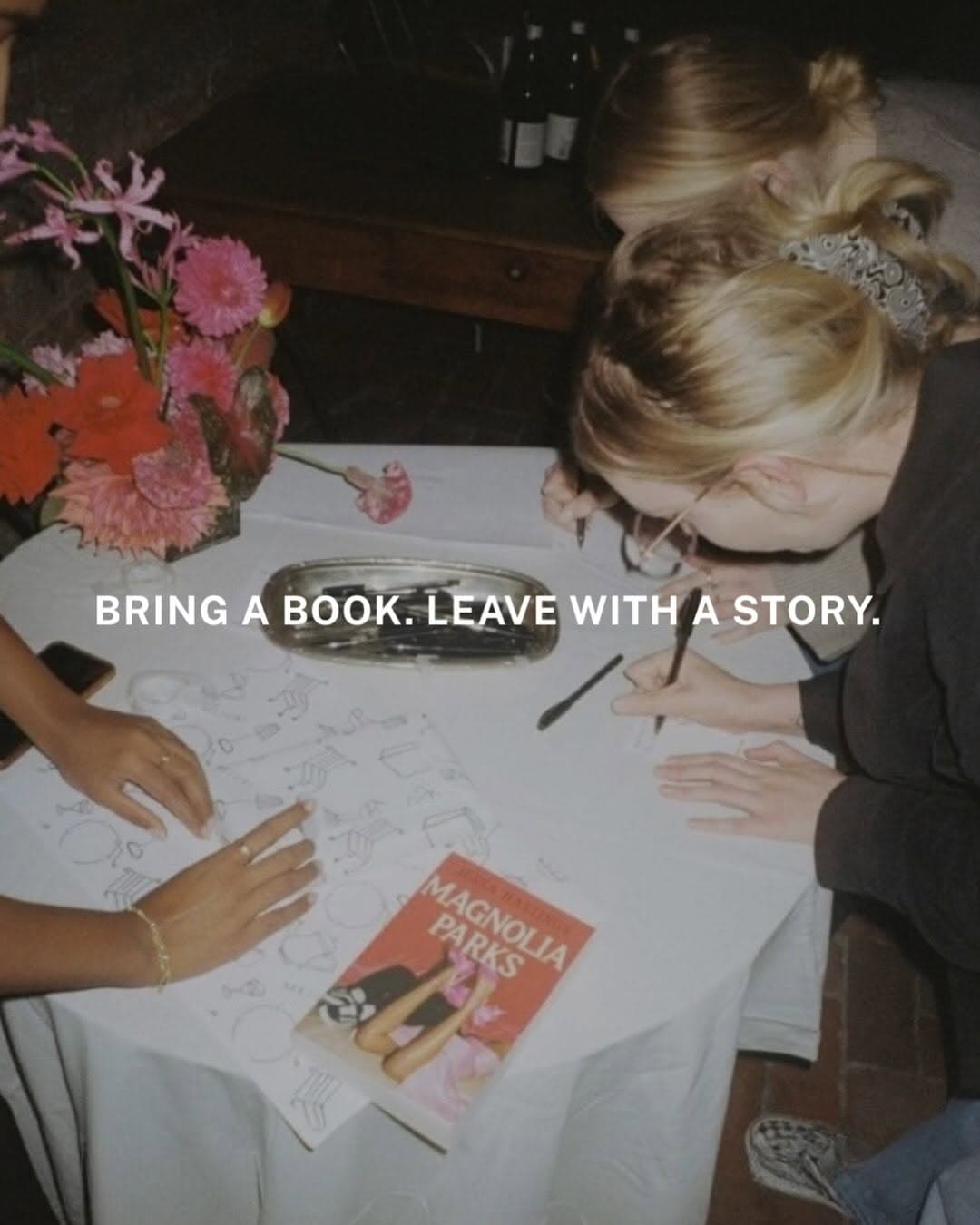 Guests seated at a dinner table at Elliots in London sharing books during the Service95 Book Club and Club Sup Book Swap Supper.